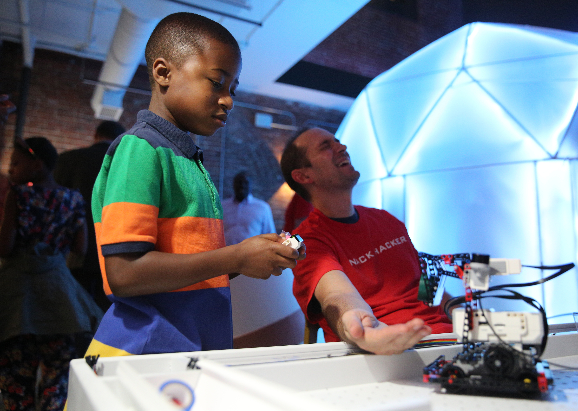 M.J. Shaw, 8, attempts to drop a roll of tape into Sam Pfister's hand from a robot at Sue's Tech Kitchen in the Tomorrow Building in Chattanooga, Tenn., Thursday, July 27, 2017. Pfister was a scientist with NASA and serves as the experience designer for Sue's Tech Kitchen, which is Randy Zuckerberg's venture to inspire children to get excited about science and technology.