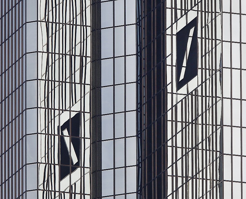 
              FILE - In this Oct.11, 2016 file phot the logos are pictured at he headquarters of Deutsche Bank in Frankfurt, Germany. Deutsche Bank announces its second-quarter earnings on Thursday, July 27, 2017. (AP Photo/Michael Probst, file)
            