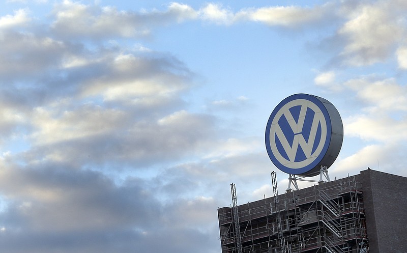 FILE - In this Sept. 26, 2015 file photo a giant logo of the German car manufacturer Volkswagen is pictured on top of a company's factory building in Wolfsburg, Germany. (AP Photo/Michael Sohn, file)
            