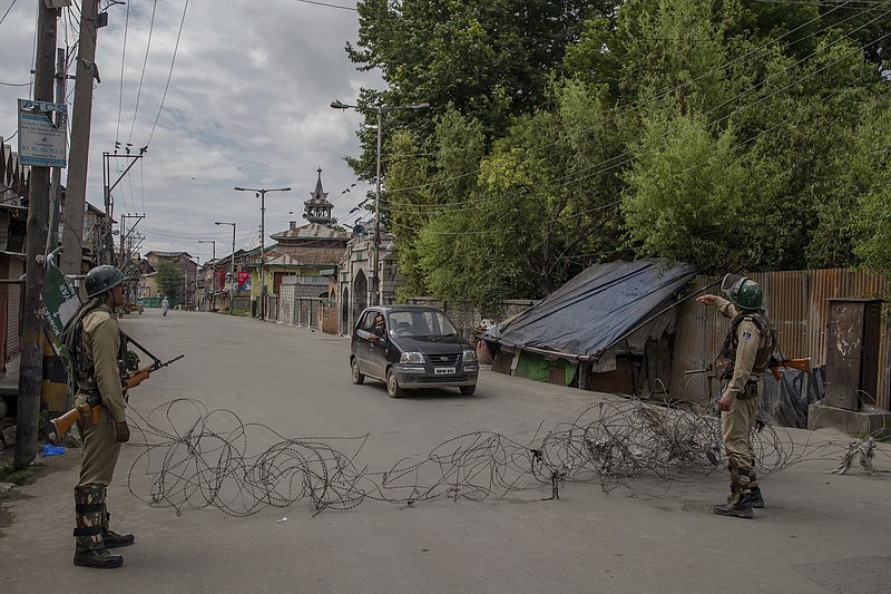 
              FILE - In this June 30, 2017 file photo, Indian paramilitary soldiers stand guard at a temporary checkpoint during a curfew in downtown area of Srinagar, Indian controlled Kashmir.  An al-Qaida-linked propaganda network announced Thursday, July 27, 2017, that a militant leader in the Indian-controlled portion of Kashmir will head a new group that will fight against Indian rule in the disputed region. It is the first time that al-Qaida has publicly claimed to be active in Kashmir.(AP Photo/Dar Yasin, File)
            
