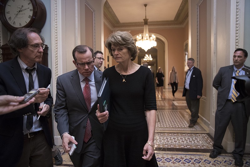 
              Sen. Lisa Murkowski, R-Alaska is approached by reporters as she enters the Senate chamber on Capitol Hill in Washington, Thursday, July 27, 2017, as the Republican majority in Congress remains stymied by their inability to fulfill their political promise to repeal and replace "Obamacare" because of opposition and wavering within the GOP ranks. (AP Photo/J. Scott Applewhite)
            