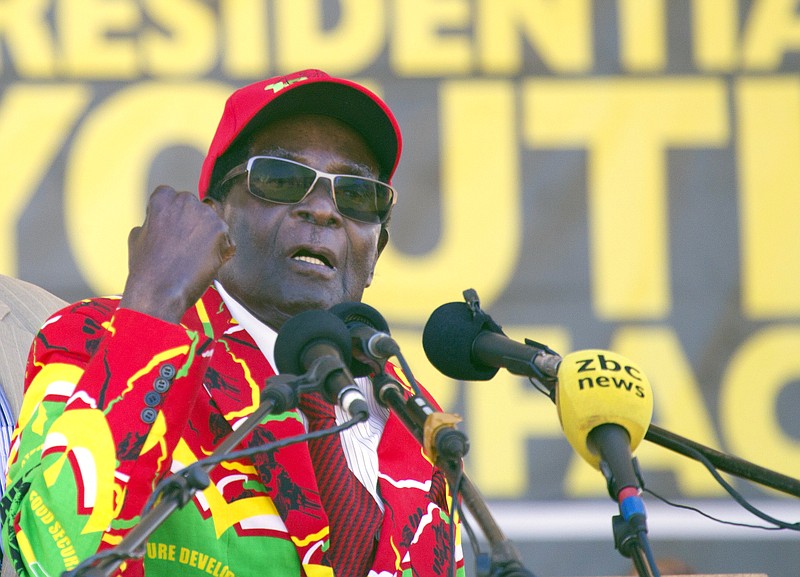 
              Zimbabwe's President Robert Mugabe greets supporters at a rally in Lupane about 170 Kilometres north of Bulawayo, Zimbabwe, Friday, July 21, 2017. Mugabe's rally is his first since his return from a routine medical review in Singapore. The world's oldest leader has launched a series of rallies targeting the youth ahead of Presidential elections set for 2018. (AP Photo/Tsvangirayi Mukwazhi)
            