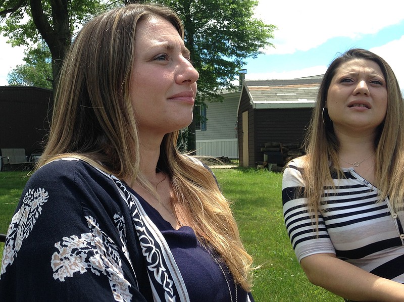 
              ADVANCE FOR USE MONDAY, JULY 31, 2017 AND THEREAFTER-In this Wednesday, June 7, 2017 photo, Denyse DeLuca, left, and her sister, Stephanie, talk about their grandfather, Eugene, outside Denyse's home in Morrisville, Pa. Eugene DeLuca was shot and killed during a 1977 store robbery by 17-year-old Joseph Evans. In a March 2017 hearing to oppose Evan's release, Stephanie told the judge, "We never got the chance to call him Grandpop, feel his hugs, see his smile ... hear his laugh or hear him tell us he loves us. The defendant murdered our grandfather and stole all those opportunities from us all." (AP Photo/Mike Householder)
            