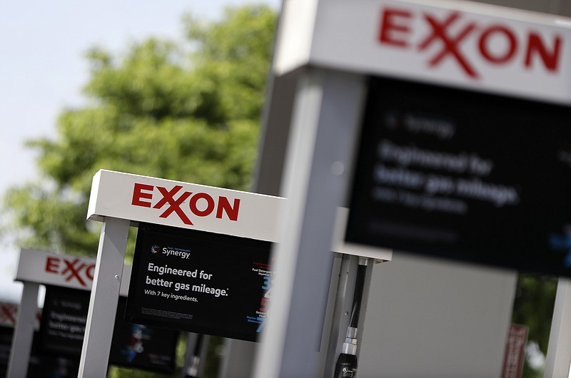 
              This April 25, 2017, photo, shows Exxon service station signs in Nashville, Tenn. Exxon Mobil Corp. reports earnings, Friday, July 28, 2017. (AP Photo/Mark Humphrey)
            
