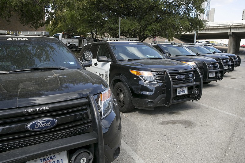 
              In this Tuesday, July 11, 2017 photo, Austin police Ford utility vehicles are parked on East Eighth Street outside police headquarters in Austin, Texas. The Austin Police Department on Friday, July 28, 2017 pulled nearly 400 Ford Explorer SUVs from its patrol fleet over worries about exhaust fumes inside the vehicles. The move comes as U.S. auto safety regulators investigate complaints of exhaust fume problems in more than 1.3 million Explorers from the 2011 through 2017 model years.(Jay Janner/Austin American-Statesman via AP)
            