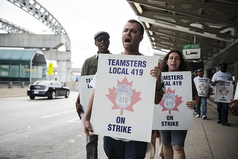 
              Striking workers picket  at Pearson International Airport in Toronto on Friday, July, 28, 2017. Canada’s busiest air hub is advising travelers to check the status of their flights and says it will provide updates as they become available.
The striking workers are employed by Swissport and include baggage and cargo handlers, cabin cleaners and other ground crew.  (Christopher Katsarov/The Canadian Press via AP)
            