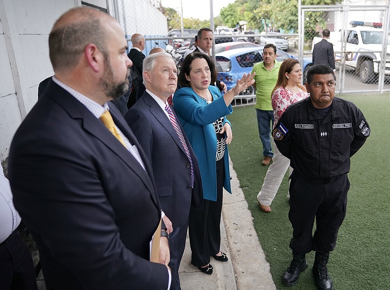 
              U.S. Attorney General Jeff Sessions, center, and U.S. Ambassador to El Salvador Jean Elizabeth Manes, right, stop to look across the courtyard during a tour of local police station and detention center in San Salvador, El Salvador, Thursday, July 27, 2017. (AP Photo/Pablo Martinez Monsivais)
            