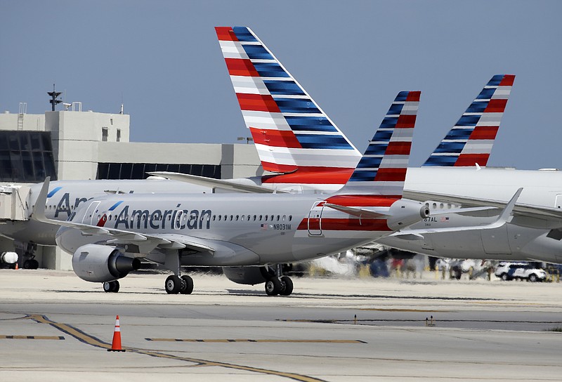 
              FILE - In this Wednesday, May 27, 2015, file photo, an American Airlines jet taxis to the gate at Miami International Airport, in Miami. American Airlines Group, Inc. reports earnings Friday, July 28, 2017. (AP Photo/Lynne Sladky, File)
            