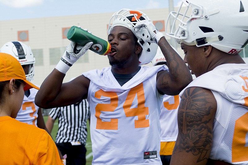 Tennessee running back Trey Coleman drinks during NCAA college football practice at Anderson Training Facility in Knoxville, Tenn., on Saturday, July 29, 2017. (Calvin Mattheis/Knoxville News Sentinel via AP)