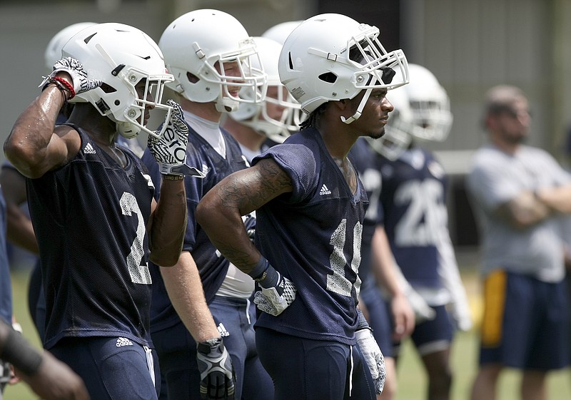 UTC defensive backs Kareem Orr (2) and Cameron Turner (16) look on while waiting their turns in preseason practice. Orr and Turner are transfers in the secondary, from Arizona State and Nevada, respectively.