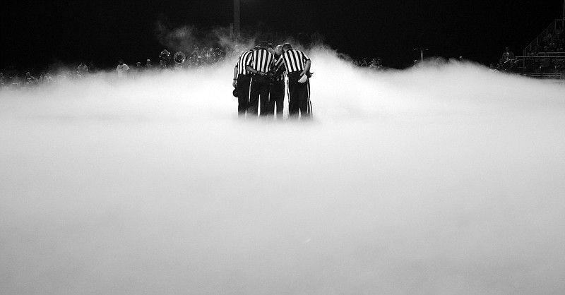 Football officials huddle before the start of the Rhea County Golden Eagles vs. East Hamilton Hurricanes game Friday night in TSSAA football action at East Hamilton High School.