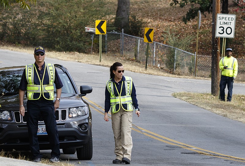 NTSB investigator in charge Robert Accetta, left, and investigator Michele Beckjord examine the road at the site of a fatal school bus crash on Talley Road on Wednesday, Nov. 23, 2016, in Chattanooga.