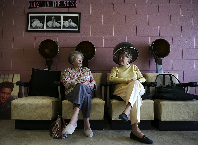 Dolores Harvey, right, dries her hair and Joan Ihrig waits while at Cara's Beauty Clinic last week. Ihrig had her hair done earlier that day and was waiting because salon owner Cara Duffy, her neighbor, was also her ride because Ihrig's car was in the shop.