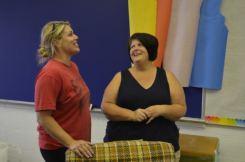 Tiffany Anich, left, talks with Rivermont Elementary teacher Barbara Crosslin about improvements made to Crosslin's classroom. Anich, along with Sam Young from Green's Eco-Build and Design, adopted Crosslin's classroom to improve it for the new school year.