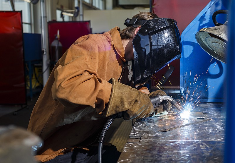 Automation mechatronics student Daniel Kowalik demonstrates a weld at the Volkswagen Academy.