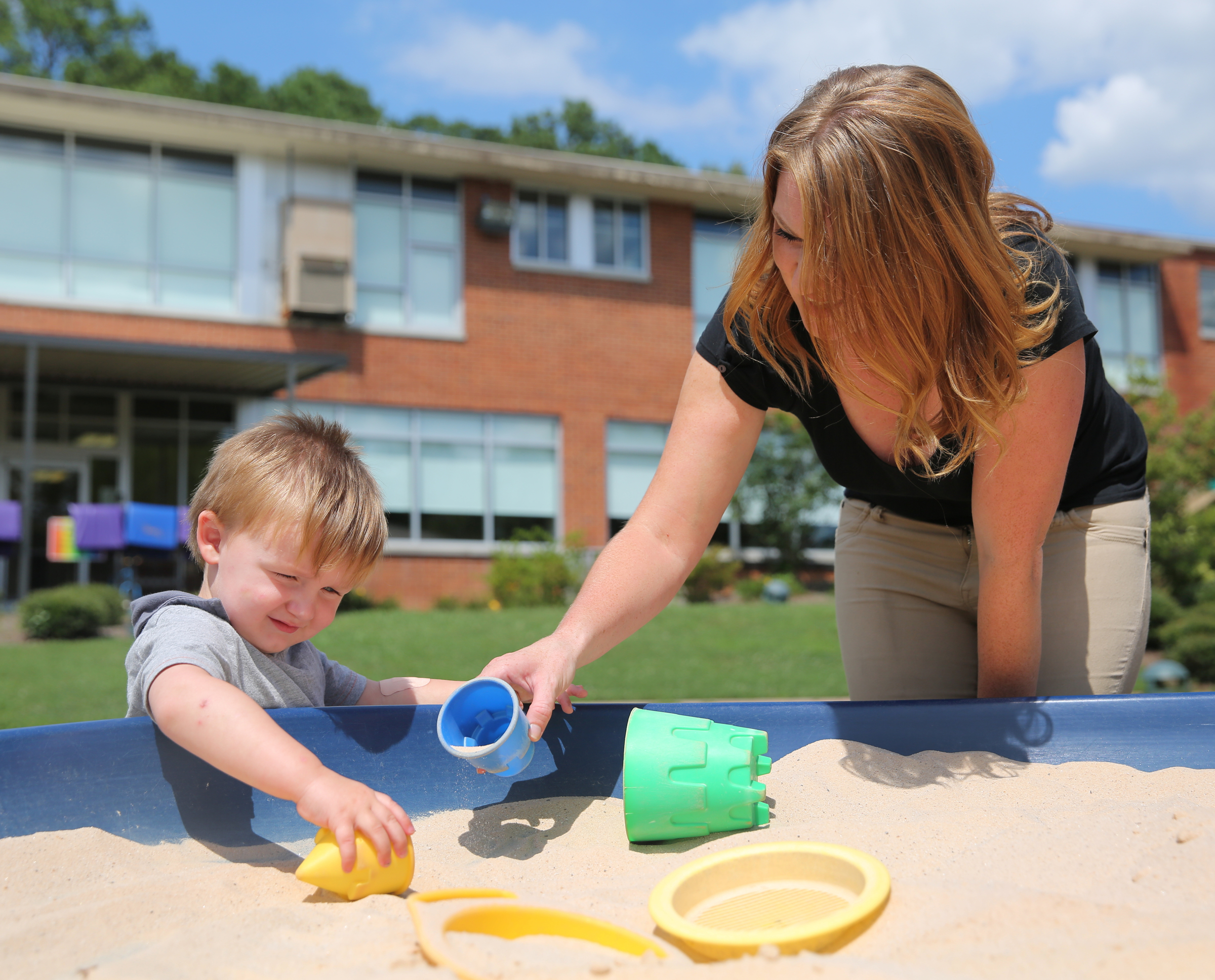Mason Snider, 2, and his mom Amanda Smothers plays in a sandbox at Signal Centers Monday, July 31, 2017, in Chattanooga, Tenn. Smothers enrolled her family in Baby University, and through Purposity, she will be receiving diapers for her son.