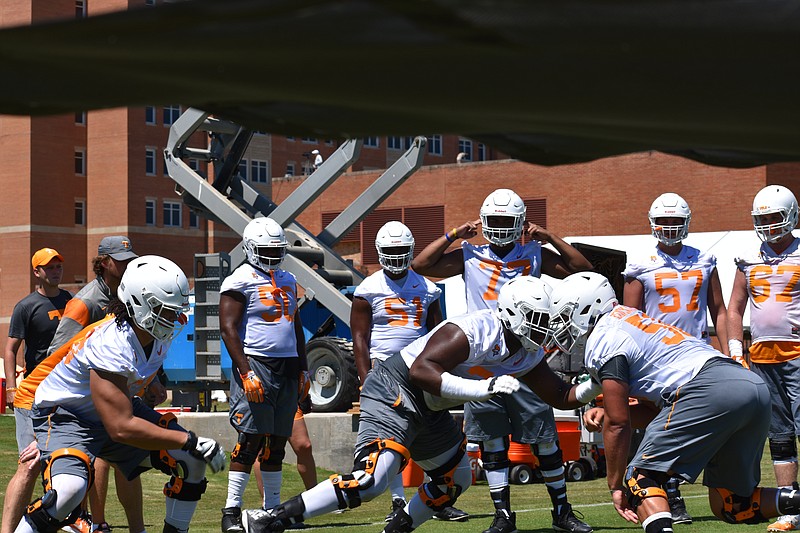 Freshman offensive lineman Trey Smith, center, blocks fellow freshman offensive lineman Riley Locklear during a drill at Tennessee football practice on July 30, 2017.