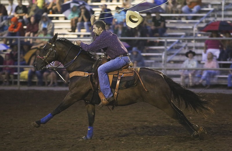 A cowboy loses his hat while competing in calf roping during a previous St. Jude Rodeo.