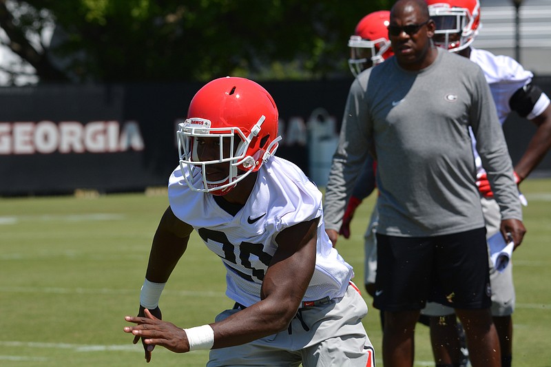 Georgia defensive back J.R. Reed practices Tuesday as Bulldogs defensive coordinator Mel Tucker watches.