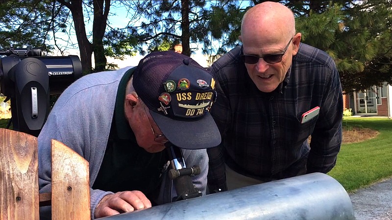 
              This frame grab from a video shows Gene Brick, 92, left, and his son, Bartt Brick, peer through a telescope in Madras, Ore., June 12, 2017, that they made together in 1964. The two plan to watch the upcoming solar eclipse together Aug. 21, 2017, as it passes through Oregon. (AP Photo/Gillian Flaccus)
            