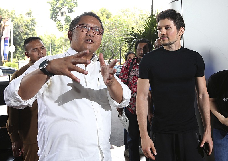 
              Indonesian Communication and Information Minister Rudiantara, left, accompanied by Telegram co-founder Pavel Durov, right, speaks as they meet in Jakarta, Indonesia, Tuesday, Aug. 1, 2017. The Indonesian government has lifted its threat to ban the encrypted messaging app Telegram because it's taking steps to address "negative" content that includes forums for Islamic State group supporters, Rudiantara said Tuesday. (AP Photo/Tatan Syuflana)
            
