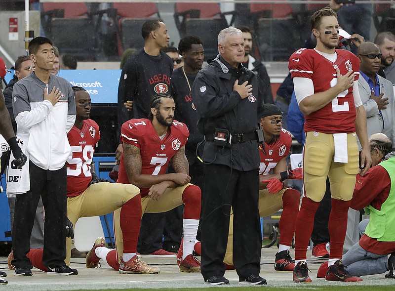 
              FILE - In this Nov. 20, 2016, file photo, San Francisco 49ers quarterback Colin Kaepernick (7) kneels next to outside linebacker Eli Harold (58) and safety Eric Reid, right rear, during the national anthem before an NFL football game against the New England Patriots in Santa Clara, Calif. It’s been a week since Baltimore Ravens coach John Harbaugh floated the idea of adding Kaepernick, a veteran who has Super Bowl experience and the baggage that comes from his decision last year to literally sit out the National Anthem on game day. (AP Photo/Marcio Jose Sanchez, File)
            