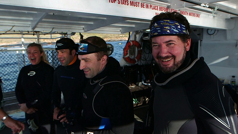 Jasmine Jade Buckland, Michael Love, Rob Hall and Brent Mills are shown on the back of the Princess 2 during the filming of "Shark Clans."