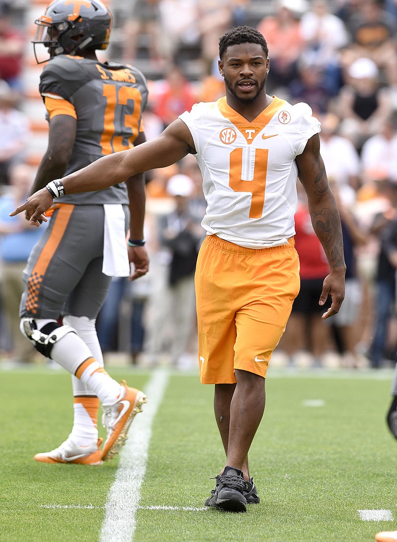 John Kelly (4) helps during warmups at Tennessee's spring game in April. The running back was held out because of a minor injury but is healthy now.