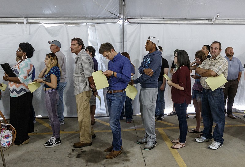 People wait in line to apply for jobs at the Amazon Fulfillment Center in Enterprise South Industrial Park on Wednesday, Aug. 2, 2017, in Chattanooga, Tenn. Amazon held nationwide job fairs Wednesday to fill 50,000 positions as the company sees a surge in growth.