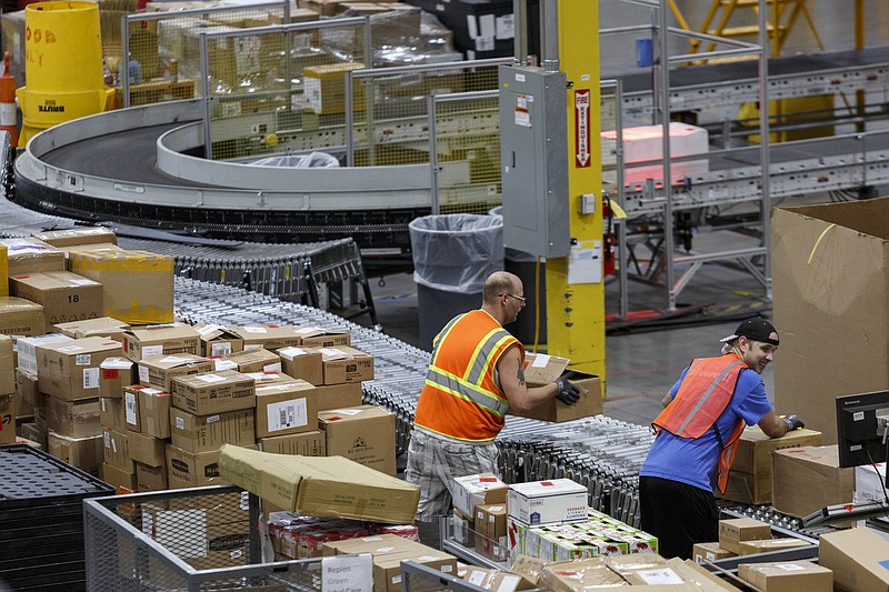 Workers unpack items shipped from affiliates to the Amazon Fulfillment Center in Enterprise South Industrial Park on Wednesday, Aug. 2, 2017, in Chattanooga, Tenn. Amazon held nationwide job fairs Wednesday to fill 50,000 positions as the company sees a surge in growth.