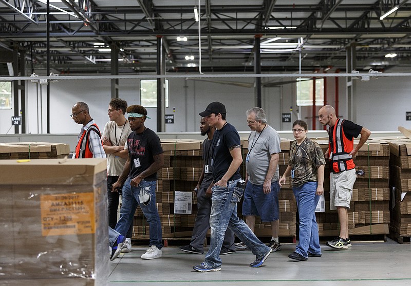 Visitors applying for jobs are given a tour of the Amazon Fulfillment Center in Enterprise South Industrial Park on Wednesday, Aug. 2, 2017, in Chattanooga, Tenn. Amazon held nationwide job fairs Wednesday to fill 50,000 positions as the company sees a surge in growth.