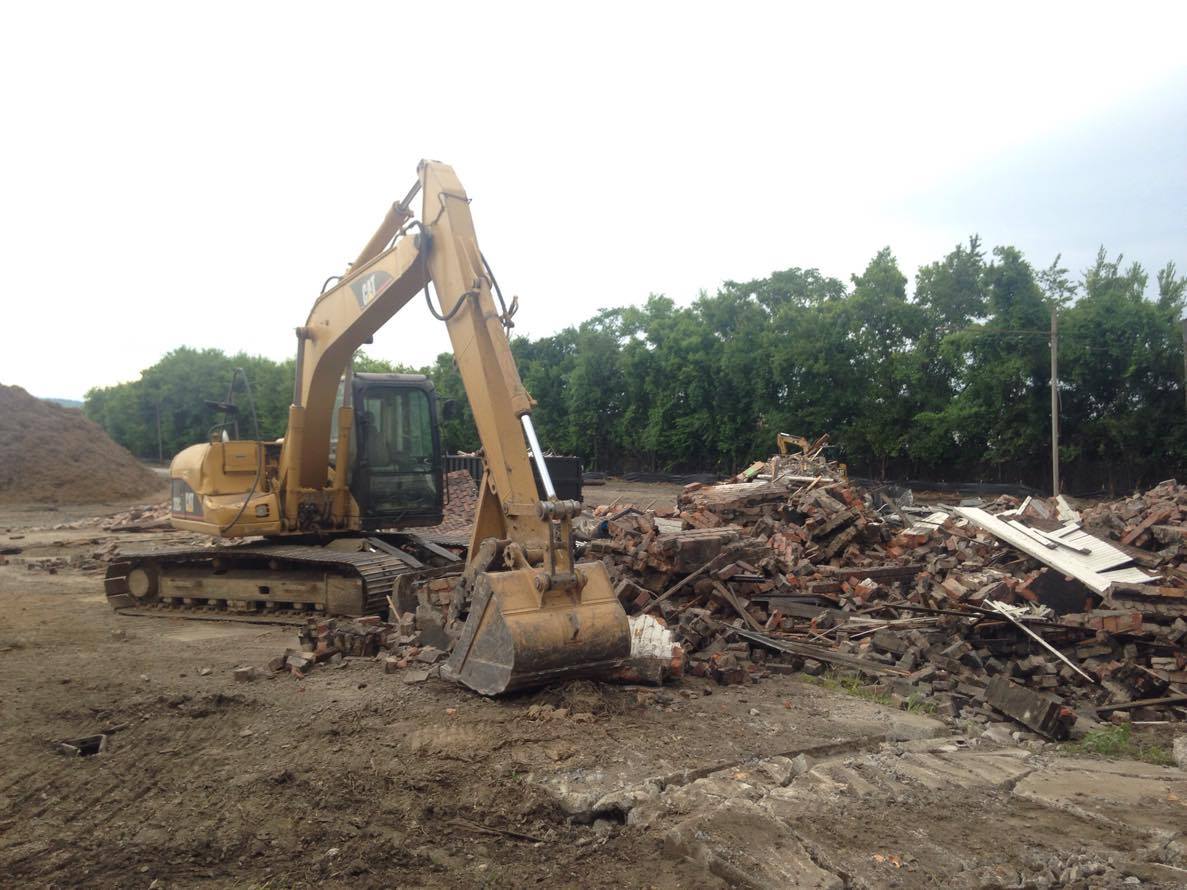 A backhoe on Tuesday tore down the historic terminal tower behind the Choo Choo Hotel.