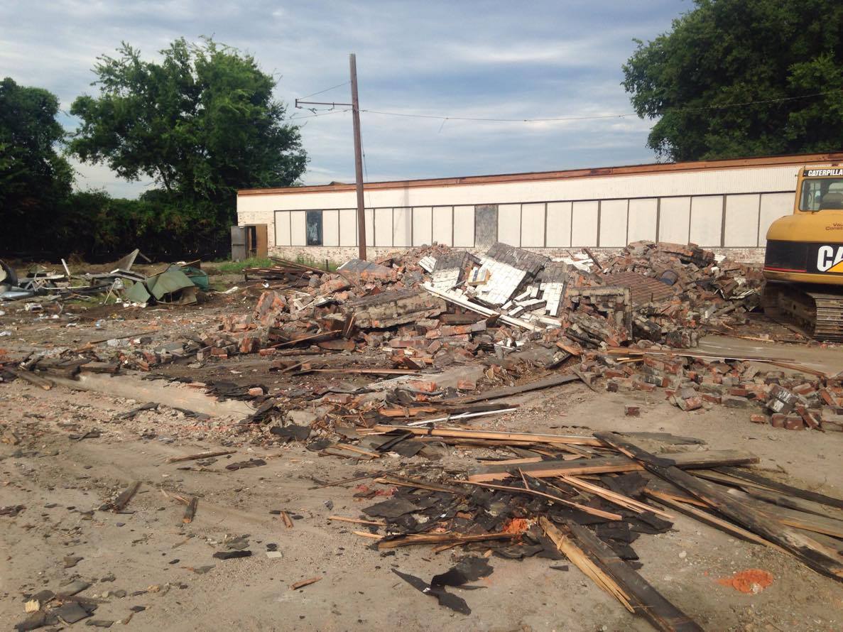 A backhoe on Tuesday tore down the historic terminal tower behind the Choo Choo Hotel.