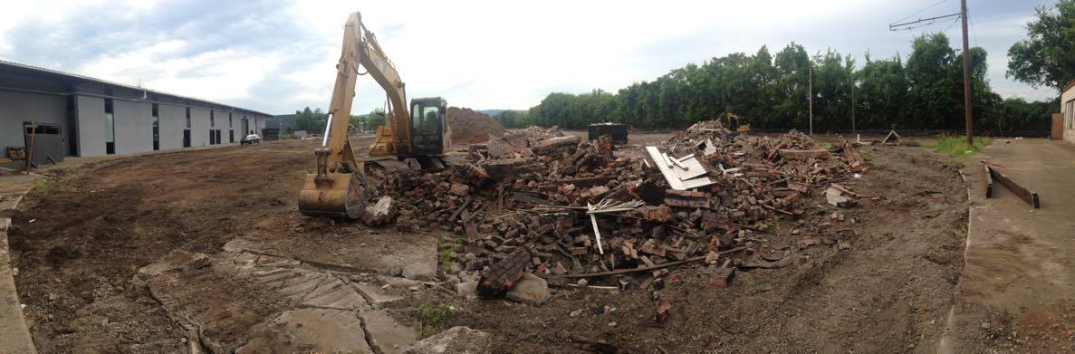 A backhoe on Tuesday tore down the historic terminal tower behind the Choo Choo Hotel.