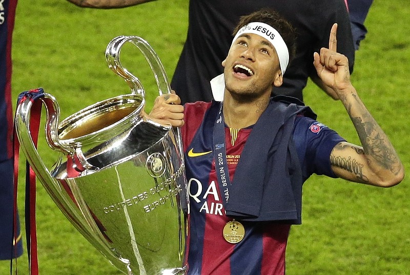 
              FILE - In this Saturday, June 6, 2015 file photo, Barcelona's Neymar celebrates with the trophy after the Champions League final soccer match between Juventus Turin and FC Barcelona at the Olympic stadium in Berlin. Barcelona said, Wednesday, Aug. 2, 2017, Neymar's 222 million euro ($262 million) release clause must be paid in full if the Brazil striker wants to leave. (AP Photo/Michael Sohn, File)
            