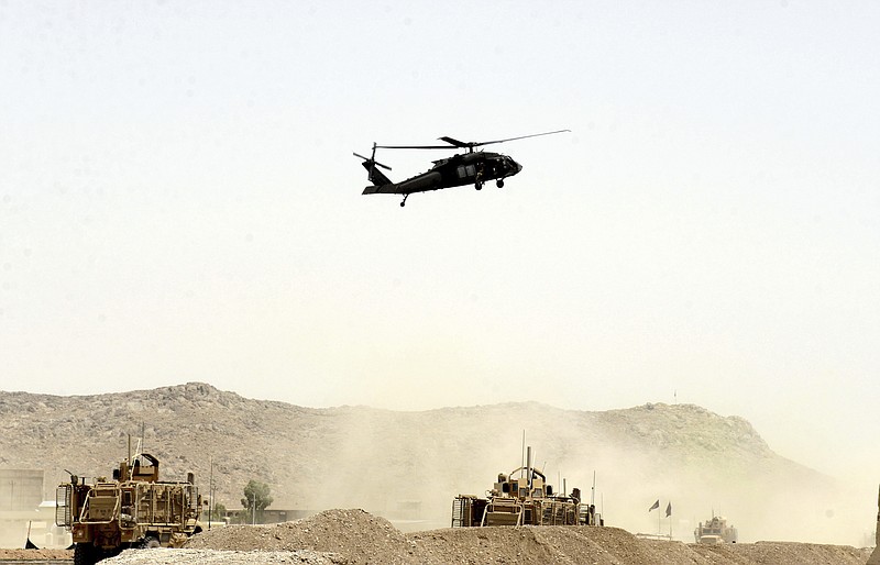 
              A US military helicopter flies over the site of a suicide bomb that struck a NATO convoy in Kandahar south of Kabul, Afghanistan, Wednesday, Aug. 2, 2017. A suicide bomber struck a NATO convoy near the southern Afghan city of Kandahar on Wednesday, causing casualties, the U.S. military said. (AP Photo)
            