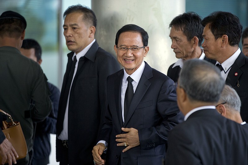 
              Thailand's former Prime Minister Somchai Wongsawat, center, smilies upon his arrival at a courthouse Wednesday, Aug. 2, 2017, in Bangkok, Thailand. A Thai court is scheduled to deliver the verdict on criminal charges against Somchai and his former deputy Chavalit Yongchaiyudh for the deadly dispersal of anti-government protesters blocking Parliament in 2008. (AP Photo/Gemunu Amarasinghe)
            