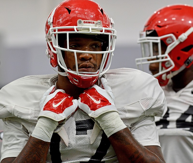Georgia senior outside linebacker Davin Bellamy takes a break during Thursday's practice, which was held in the new indoor facility. Bellamy was among four prominent players who announced last December that they were returning to Georgia.