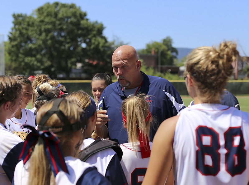 Greg Muir talks to the Frost Falcons before their game against the Williamsburg (Va.) Starz Gold during the Amateur Softball Association's 14-under girls' fastpitch national tournament at Warner Park on Monday, July 31, in Chattanooga, Tenn.