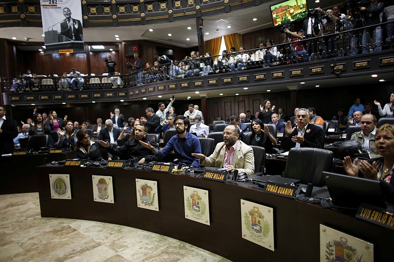 
              Opposition lawmakers shout "Fraud, fraud during a session of Venezuelan National Assembly in Caracas, Venezuela, Wednesday, Aug. 2, 2017. The CEO of the voting technology company Smartmatic said Wednesday that results of Venezuela's election for an all-powerful constituent assembly were off by at least 1 million votes. (AP Photo/Ariana Cubillos)
            
