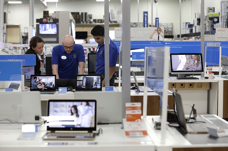 
              In this Tuesday, May 23, 2017, photo, employees assist a customer with a computer at Best Buy in Cary, N.C. On Thursday, Aug. 3, 2017, the Institute for Supply Management, a trade group of purchasing managers, issues its index of non-manufacturing activity for July. (AP Photo/Gerry Broome)
            