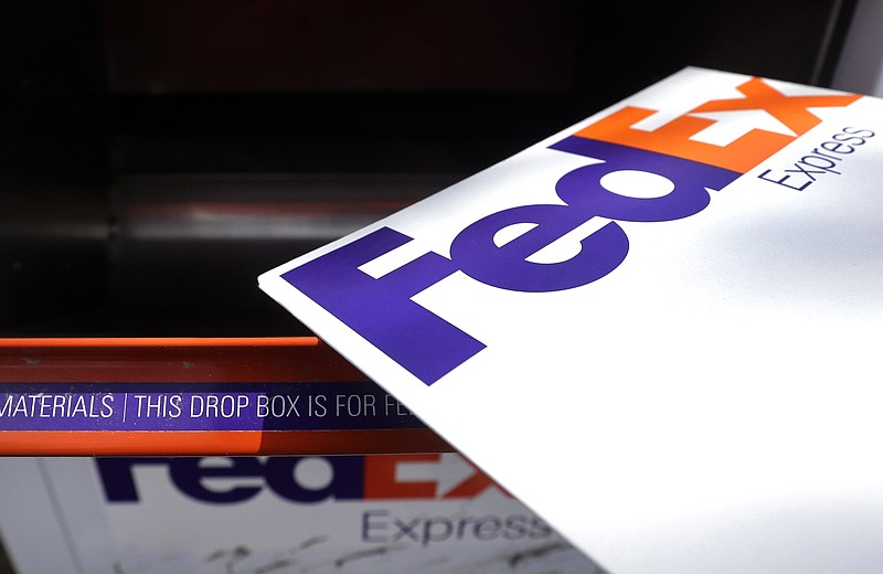 In this April 10, 2017, photo, a FedEx envelope is placed into a dropbox in North Andover, Mass. (AP Photo/Elise Amendola)
            