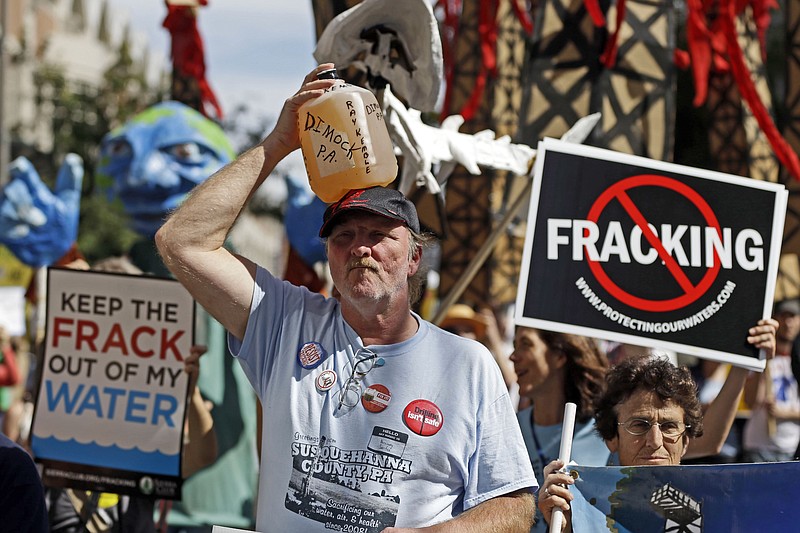 
              FILE – In this Sept. 20, 2012 file photo, Ray Kemble, of Dimock, Pa., holds a jug of his well water on his head while marching with demonstrators against hydraulic fracturing outside a Marcellus Shale industry conference in Philadelphia. Federal government scientists are collecting water and air samples in the first week of August 2017 from about 25 homes in Dimock, Pa., a tiny, rural crossroads about 150 miles north of Philadelphia that became a flashpoint in the national debate over fracking to investigate ongoing complaints about the quality of the drinking water. (AP Photo/Matt Rourke, File)
            