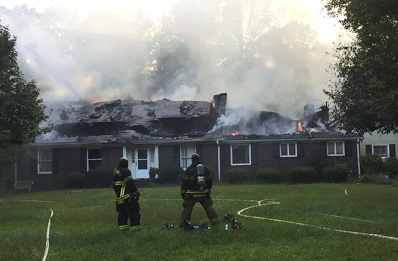 
              In this photo provided by Fayette County Department of Fire & Emergency Services , a home burns during a fire on Sunday, July 30, 2017, in Fayetteville, Ga. According to authorities, the blaze started when the homeowners lit a small stick on fire in an attempt to remove some bees near a gutter. (Fayette County Department of Fire & Emergency Services via AP)
            