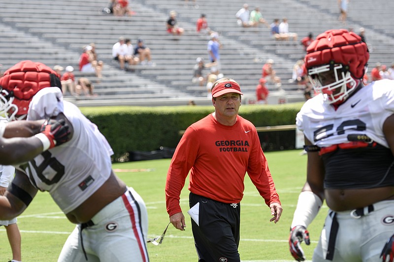 Georgia football coach Kirby Smart directs the defensive line last August during an open practice inside Sanford Stadium.