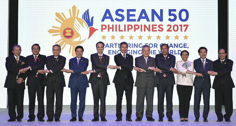 
              ASEAN Foreign Ministers link hands "The ASEAN Way" at the opening ceremony of the 50th ASEAN Foreign Ministers Meeting at the Philippine International Convention Center Saturday, Aug. 5, 2017 in suburban Pasay city, south of Manila, Philippines. They are, from left, Malaysia's Anifah Aman, Myanmar's U Kyaw Tin, Thailand's Don Pramudwinai, Vietnam's Pham Binh Minh, Philippines' Alan Peter Cayetano, Singapore's Vivian Balakrishnan, Brunei's Lim Jock Seng, Cambodia's Prak Sokhonn, Indonesia's Retno Marsudi, Laos' Saleumxay Kommasith and ASEAN Secretary-General Le Luong Minh. (AP Photo/Mohd Rasfan, Pool)
            