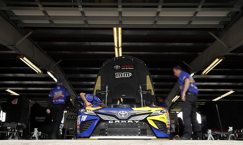 
              Crew members work on the car of Kyle Busch before practice for Sunday's NASCAR Cup Series auto race, Saturday, Aug. 5, 2017, in Watkins Glen, N.Y. (AP Photo/Matt Slocum)
            