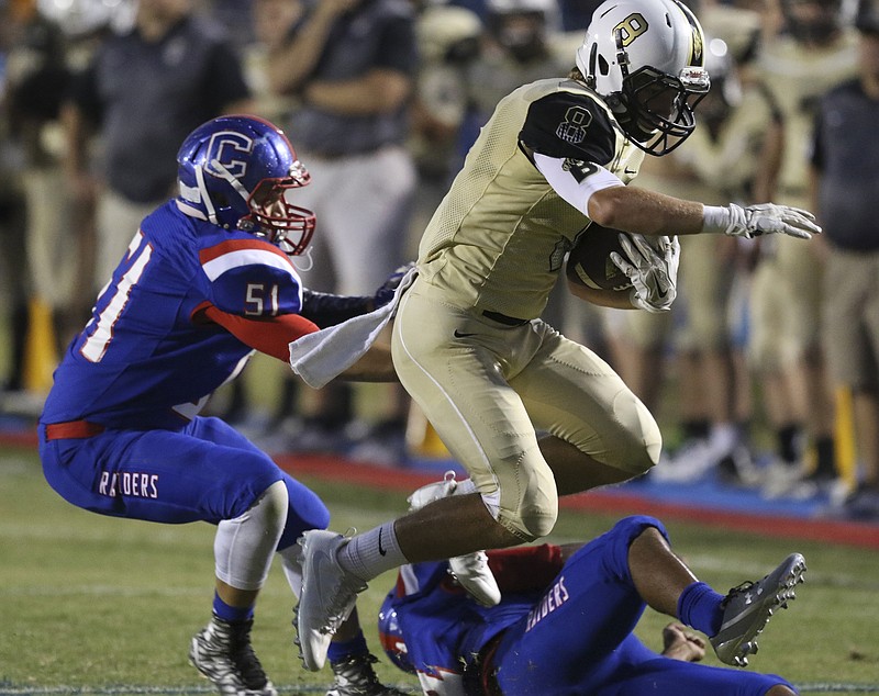Staff Photo by Dan Henry / The Chattanooga Times Free Press- 9/9/16. Bradley Central's Dylan Standifer (8) dodges a tackle by Cleveland's Ashton Dunn (51) to score a touchdown during the first half of play at the Blue Raiders' home field on Friday, September 9, 2016. 