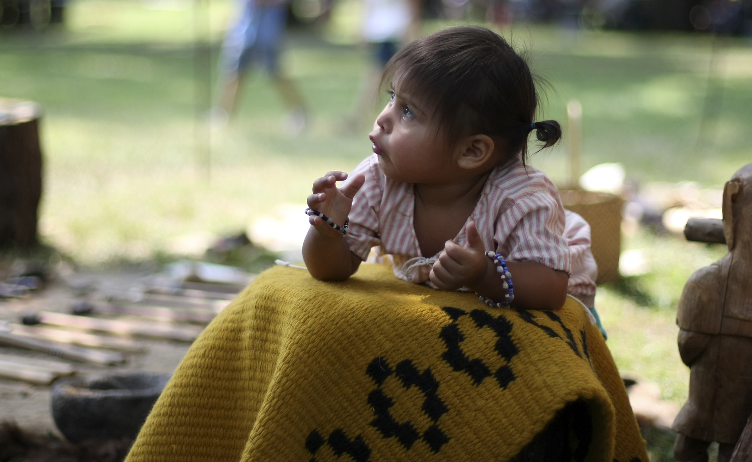 Twenty-month-old Winter Brown plays at a hunter's bark encampment during the 2017 Cherokee Cultural Celebration at Red Clay State Historic Park on Sunday, Aug. 6, in Cleveland, Tenn.