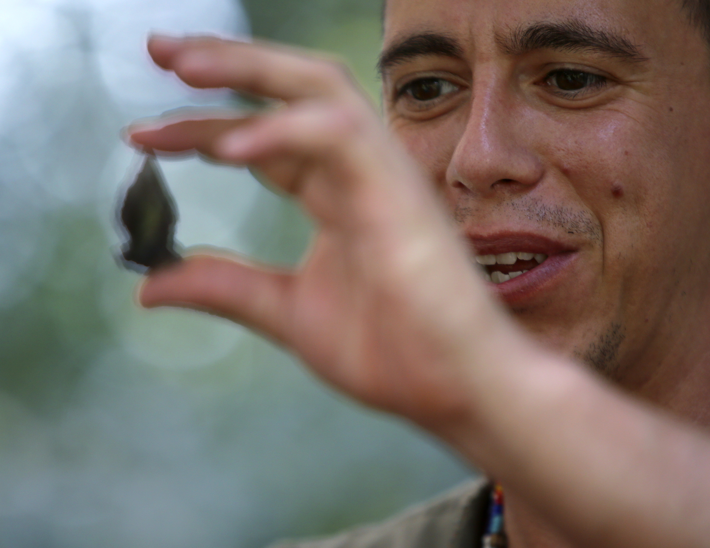 Jeremy Arch holds up a finished arrowhead during the 2017 Cherokee Cultural Celebration at Red Clay State Historic Park on Sunday, Aug. 6, in Cleveland, Tenn.